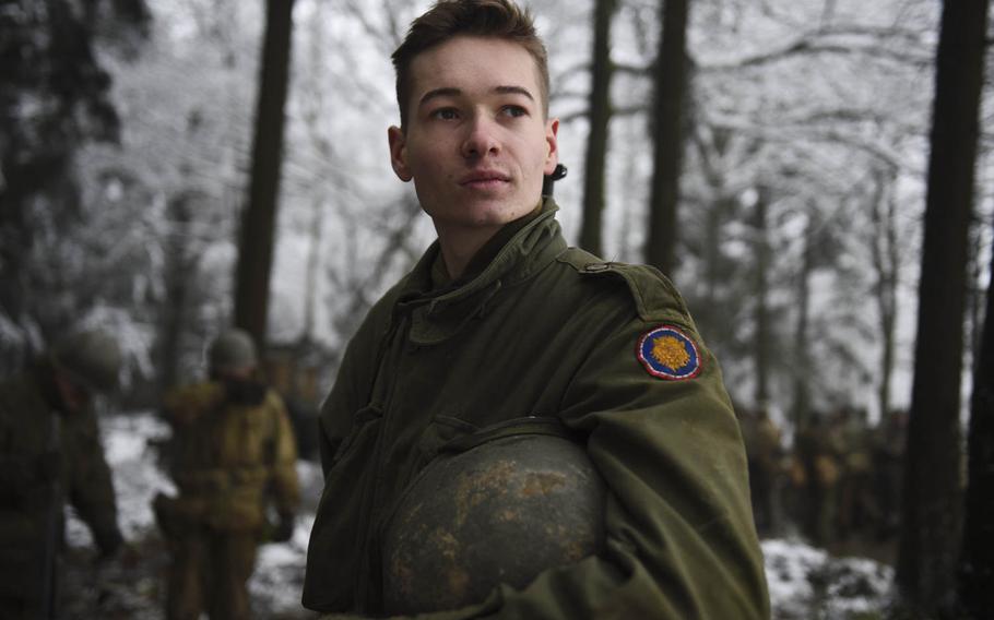 Koen Monnickendam looks back at the line of foxholes he and other re-enactors occupied on Dec. 15, 2014, while portraying the 106th Infantry Division in the very forest that unit fought in 70 years ago during the Battle of the Bulge.