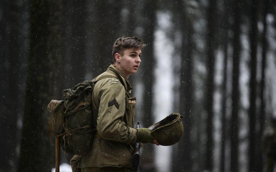 Leonard van Oord takes his helmet off to listen for enemy movement while portraying a squad leader of the 106th Infantry Division as part of a re-enactment on Dec. 13, 2014. The 106th fought in the same forest 70 years ago during the Battle of the Bulge.