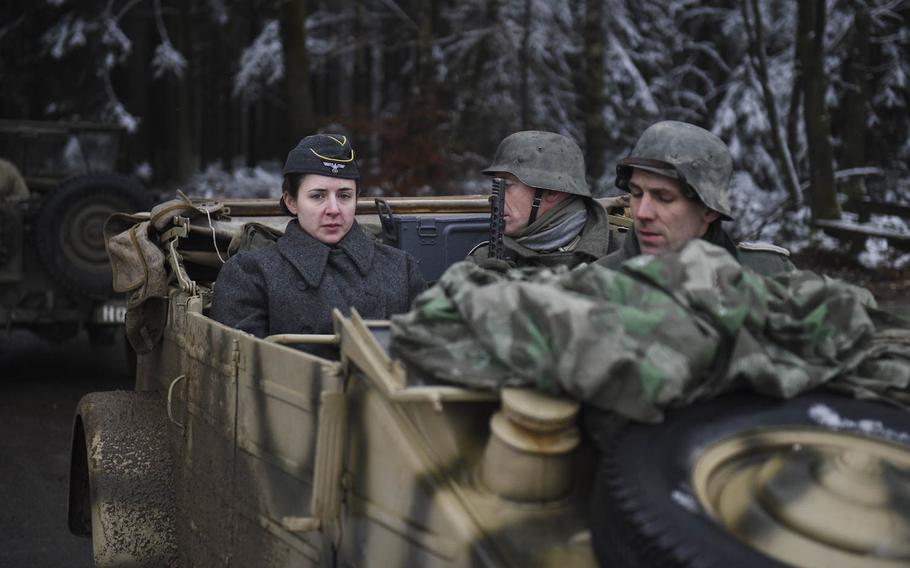 Re-enactors portray German forces on Dec. 15, 2014, as they fight re-enactors portraying the 106th Infantry Division in the heights above St. Vith, Belgium, where the 106th fought during the Battle of the Bulge 70 years ago.
