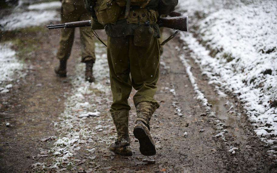 Wesley van Reen patrols with his squad in the heights above St. Vith, Belgium, during a re-enactment on Dec. 13, 2014. He and others portrayed the 106th Infantry Division, which fought in the Battle of the Bulge 70 years ago.