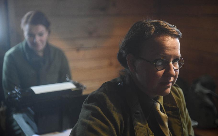 Judith  Cornelissen, front, and Nicole Uyen portray administrative clerks in a Battle of the Bulge re-enactment Saturday, Dec. 13, 2014. The re-enactors portrayed the 106th Infantry Division, which fought German forces in the heights above St. Vith, Belgium, 70 years ago.
