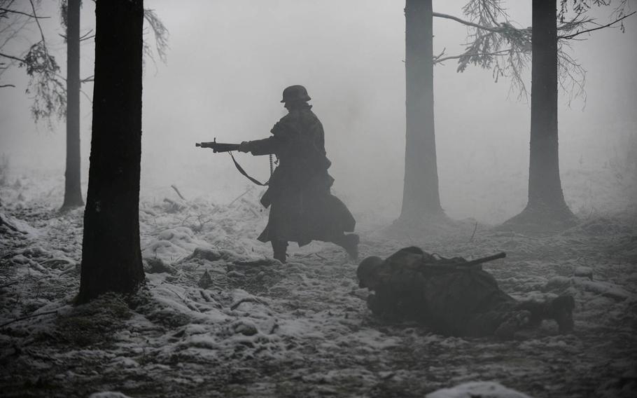 Re-enactors portray German forces as they fight fellow re-enactors portraying the 106th Infantry Division on Dec. 15, 2014. The Battle of the Bulge re-enactment took place in the heights above St. Vith, Belgium, where the 106th fought 70 years ago.