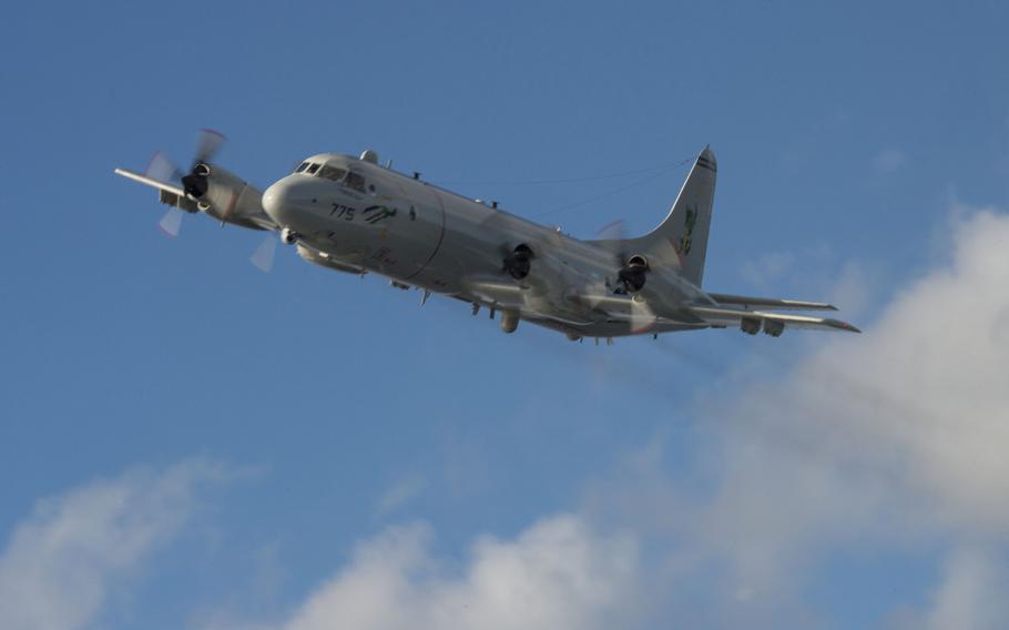 A Navy P-3C Orion maritime patrol aircraft attached to Patrol Squadron 4 conducts a fly-by of the guided-missile destroyer USS Cole in this Navy file photo. In December VP-4 participated in operations off the coast of Scotland, which British and American media described as a search for a foreign submarine.