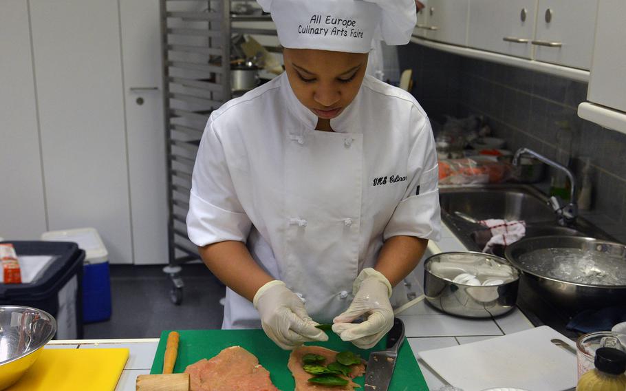 Chelsi Wright of Vilseck team No. 1 prepares her team's entree of chicken roulade stuffed with ham, spinach and sun-dried tomatoes at the 2015 DODDS-Europe Culinary Faire held at Kaiserslautern High School on Feb. 25, 2015.