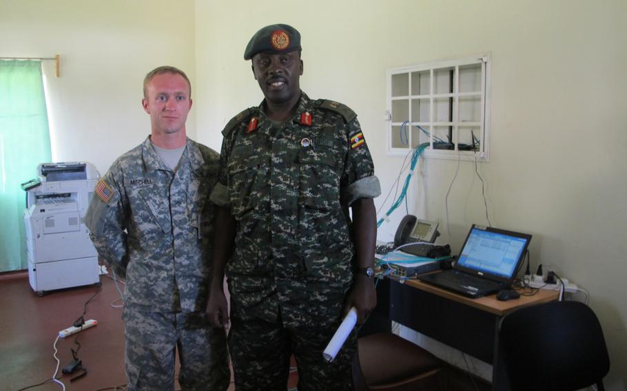 Pvt. Cody Mitchell poses for a photograph with Ugandan Brig. Gen. Matthew Gureme during the military exercise Eastern Accord in Jinja, Uganda.Gureme was exercise director.