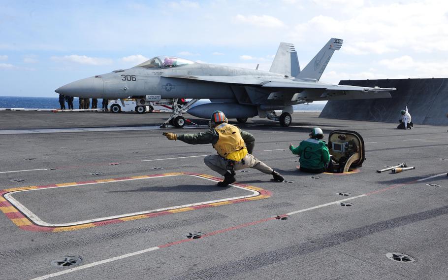 An F/A-18F Super Hornet assigned to the Knighthawks of Strike Fighter Attack Squadron (VFA) 136 prepares to launch from the flight deck of the USS Theodore Roosevelt, March 12, 2015. Theodore Roosevelt is deployed to conduct operations in the U.S.5th, 6th and 7th Fleet areas of responsibility.