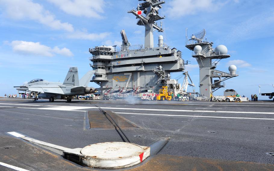 An F/A-18F Super Hornet assigned to the Checkmates of Strike Fighter Attack Squadron (VFA) 211 makes an arrested recovery on the flight deck of the Nimitz-class aircraft carrier USS Theodore Roosevelt March 12, 2015. Theodore Roosevelt will conduct operations in the U.S. Navy's 5th, 6th, and 7th Fleet areas of responsibility.