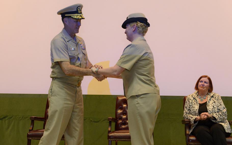 Commander of U.S. Naval Forces Europe-Africa Adm. Mark Ferguson congratulates Fleet Master Chief JoAnn Ortloff during her retirement ceremony on Friday, March 20, 2015. Ortloff, who joined the Navy in 1982, was the most senior enlisted active-duty female in the Navy at the time of her retirement.