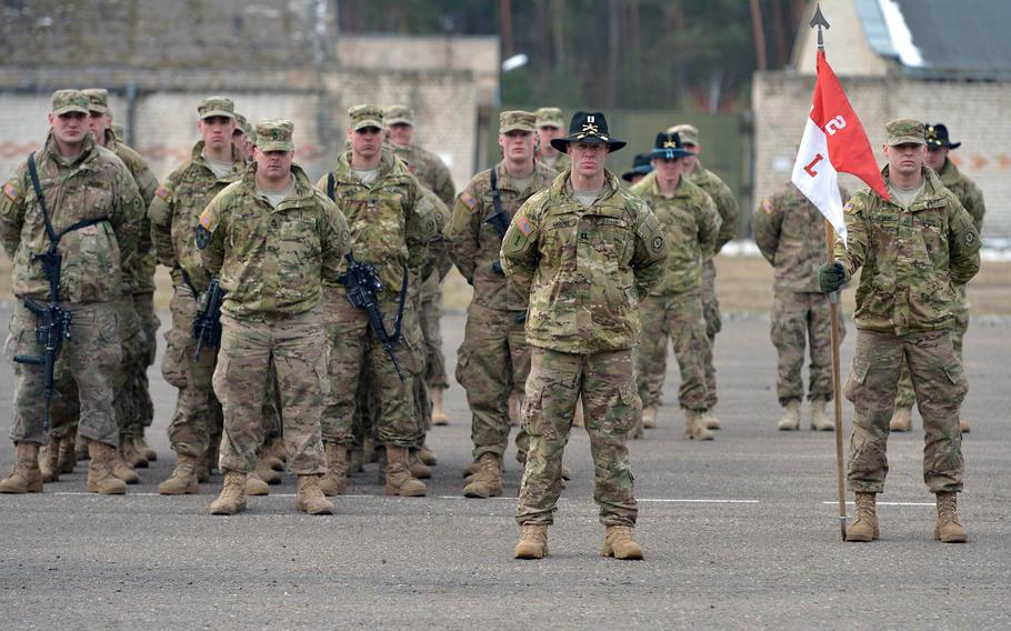 Soldiers of Lightning Troop, 3rd Squadron, 2nd Cavalry Regiment, under Capt. Russell Moore, center, listen to speeches during a farewell ceremony in Alytus, Lithuania, Monday, March 23, 2015. The Strykers of Lightning Troop,  and their supporting units began their Dragoon Ride convoy home to Vilseck, Germany, through Lithuania, Poland and the Czech Republic, following training in Lithuania.