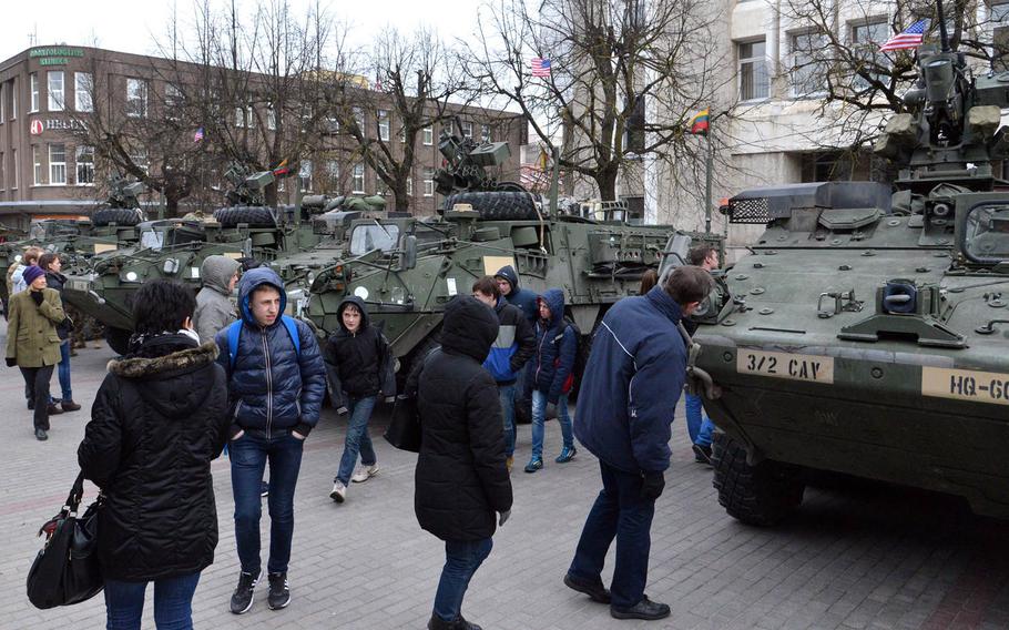 People check out the Strykers of Iron Troop, 3rd Squadron, 2nd Cavalry Regiment during a static display of the unit's Strykers in downtown Panevezys, Lithuania, Monday, March 23, 2015. The soldiers of Iron Troop made a stop in Panevezys during their convoy back to their home base in Vilseck, Germany, as part of the so-called Dragoon Ride, after training in Estonia.