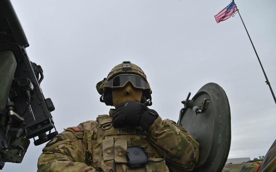 Sgt. Gregory Loomis of Iron Troop, 3rd Squadron, 2nd Cavalry Regiment talks on the radio during a stop on the outskirts of Panevezys, Lithuania, Monday, March 23, 2015. The soldiers of Iron Troop were convoying back to their home base in Vilseck, Germany, as part of the so-called Dragoon Ride, after training in Estonia.