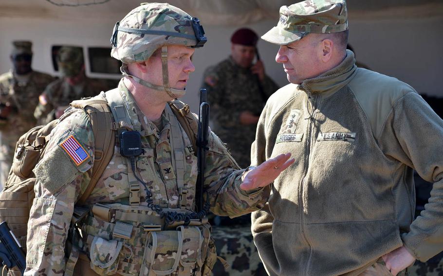 Col. Michael Foster, commander of the 173rd Airborne Brigade, left, talks to U.S. Army Europe commander Lt. Gen. Ben Hodges after Foster and other soldiers of his unit  jumped into the Smardan training center, Romania, Tuesday, March 24, 2015.