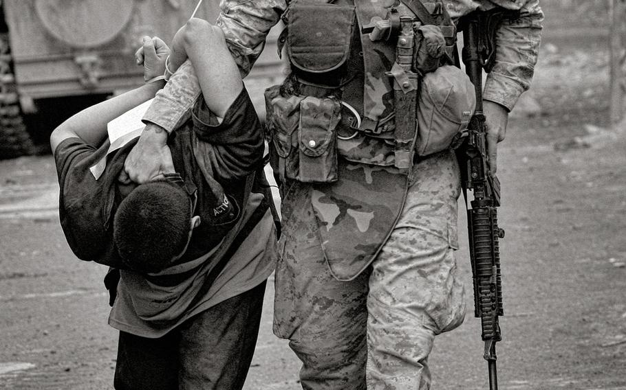 A U.S. Marines handles a detainee at the start of the second battle of Fallujah, Iraq.