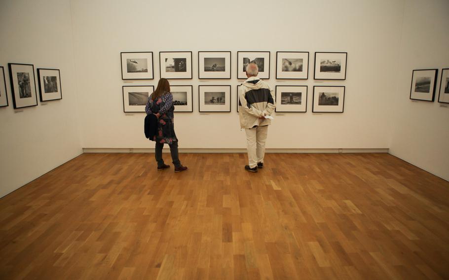 Visitors to Kaiserslautern's Pfalzgalerie look at photographs by slain war photographer Anja Niedringhaus, who was killed while covering the Afghan elections in April 2014.