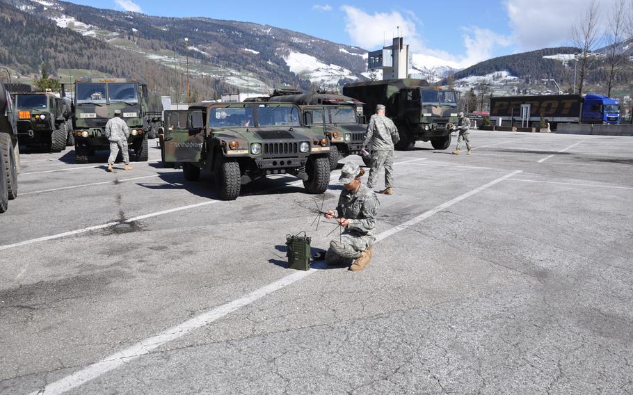 Paratroops from the 173rd Airborne Brigade Support Battalion check equipment and send a satellite transmission April 7, 2015, near Trento, Italy. The convoy moved from the battalion's home station in Vicenza to Yavoriv, Ukraine, to deliver training equipment for Operation Fearless Guardian.