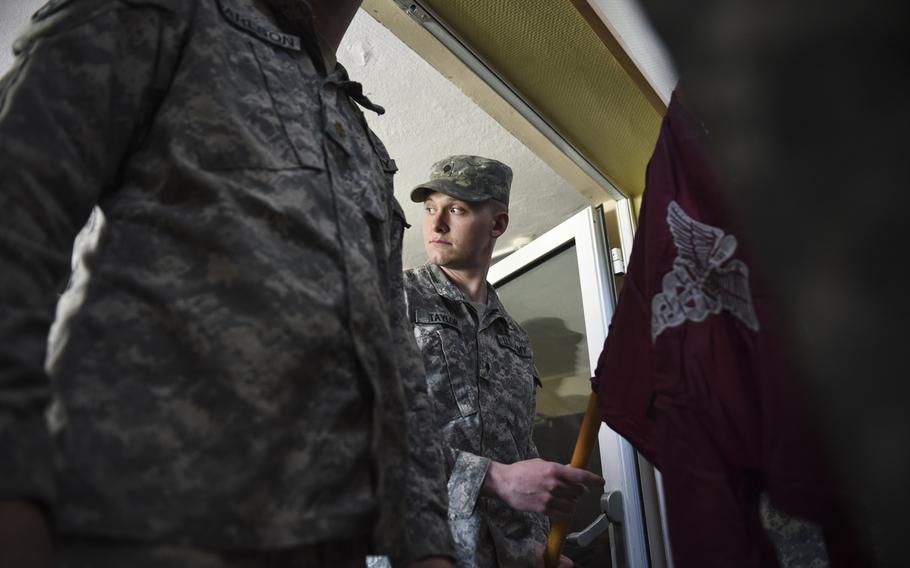 Spc. Andrew Taylor prepares to lead the 16 other soldiers of his unit, the 67th Forward Surgical Team, as the guidon bearer into the gymnasium on Miesau Army Depot, Germany, Tuesday, April 14, 2015. The 67th FST returned from a nine-month deployment to Iraq.