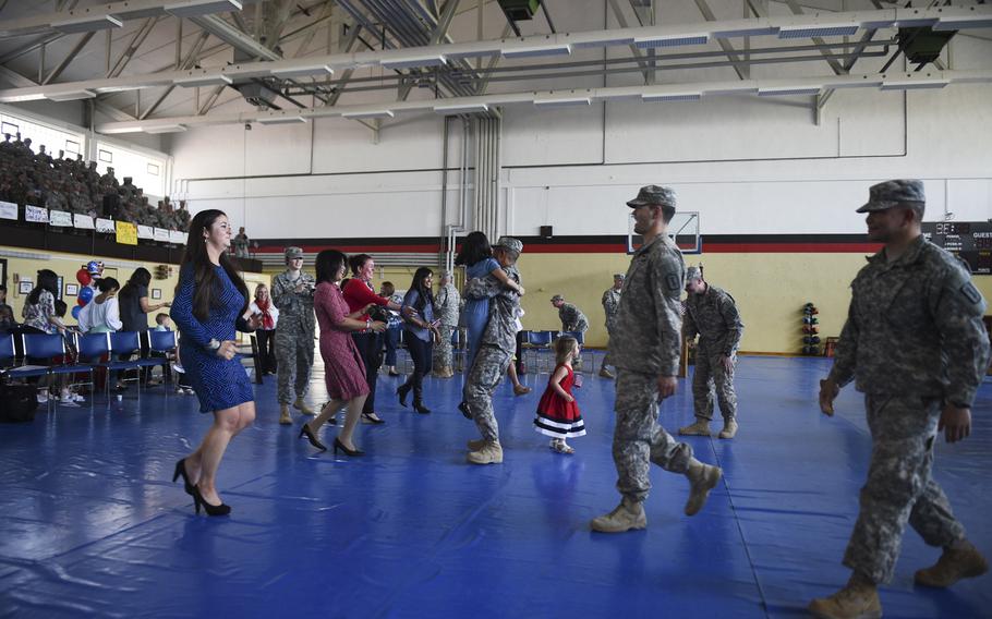 Family members rush toward one another as they welcome home 17 soldiers with the 67th Forward Surgical Team in the gymnasium on Miesau Army Depot, Germany, Tuesday, April 14, 2015. The soldiers returned from a nine-month deployment to Iraq.
