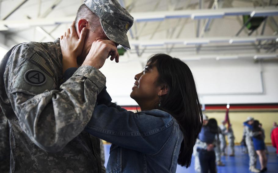 Rowena Castro and Maj. Nathan Carlson reunite as 17 soldiers with the 67th Forward Surgical Team return from a nine-month deployment to Iraq in the gymnasium on Miesau Army Depot, Germany, Tuesday, April 14, 2015.