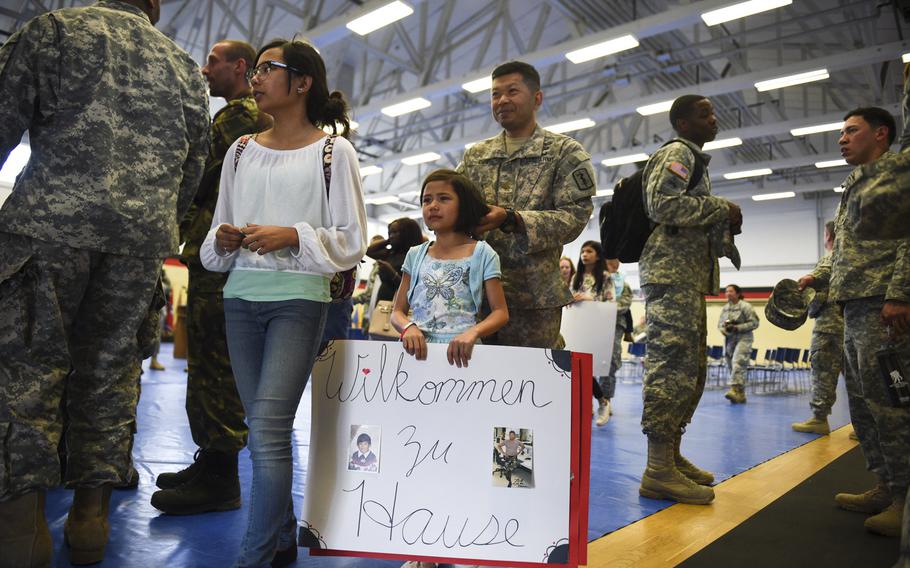 David Dee reunites with his wife, Stacy and daughter Bryce as he and 16 other soldiers with the 67th Forward Surgical Team return from a nine-month deployment to Iraq in the gymnasium on Miesau Army Depot, Germany, Tuesday, April 14, 2015.