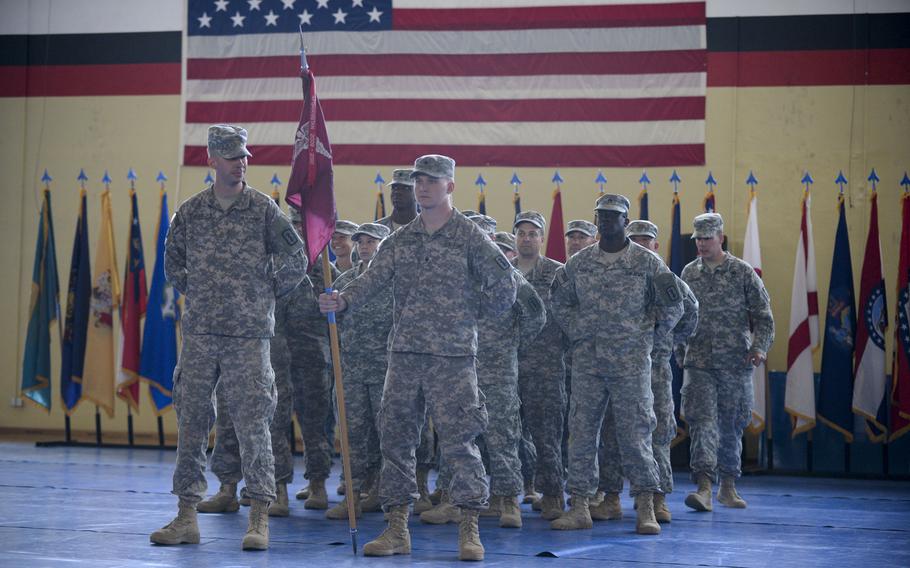 Seventeen soldiers with the 67th Forward Surgical Team stand in formation in the gymnasium on Miesau Army Depot, Germany as they return from a nine month deployment to Iraq, Tuesday, April 14, 2015.