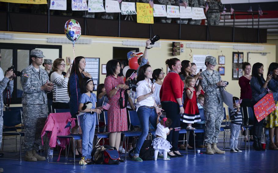 Friends and family welcome home 17 soldiers with the 67th Forward Surgical Team after their return from a nine-month deployment to Iraq in the gymnasium on Miesau Army Depot, Germany, Tuesday, April 14, 2015.