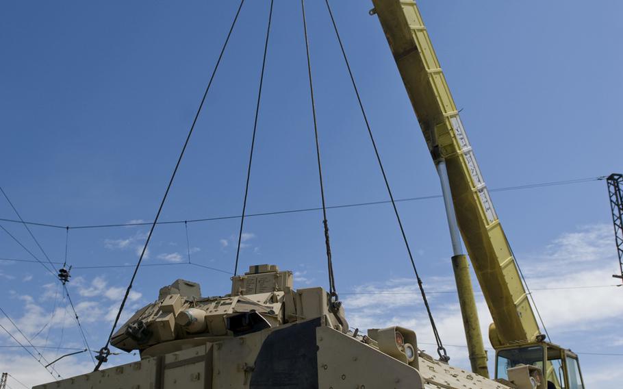 A Bradley Infantry Fighting Vehicle is offloaded from a rail car in Tbilisi, Georgia, for movement to the Vaziani training area, where U.S. and Georgian troops will conduct two weeks of training in the Noble Partner 15 exercise, Thursday, May 7, 2015.