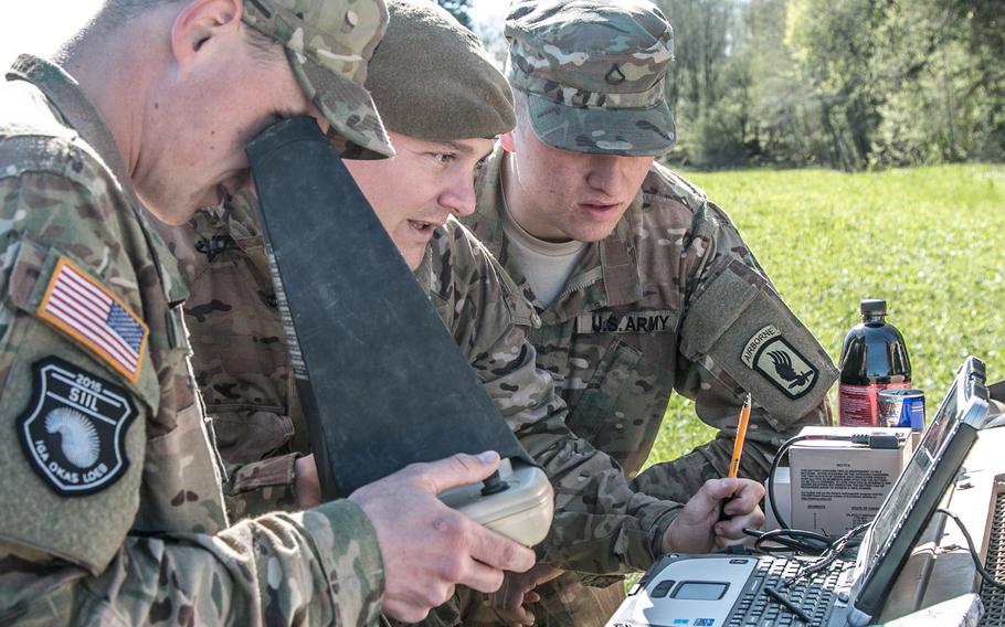 Sgt. Eric Cole, left, and Pfc. Nicholas Gatoura, right, of 1st Squadron, 91st Cavalry Regiment, 173rd Airborne Brigade, explain how to control an RQ-11 Raven unmanned aerial vehicle to British Capt. Richard Merchant of 2nd Battalion, Yorkshire Regiment, during Operation Siil outside Johvi, Estonia, May 9, 2015.