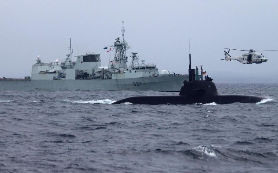 German submarine U33, Canadian frigate HMCS Fredericton and a helicopter from Netherlands frigate HNLMS Tromp participate in the first day of the annual exercise Dynamic Mongoose 2015 off the coast of Norway, May 4, 2015.