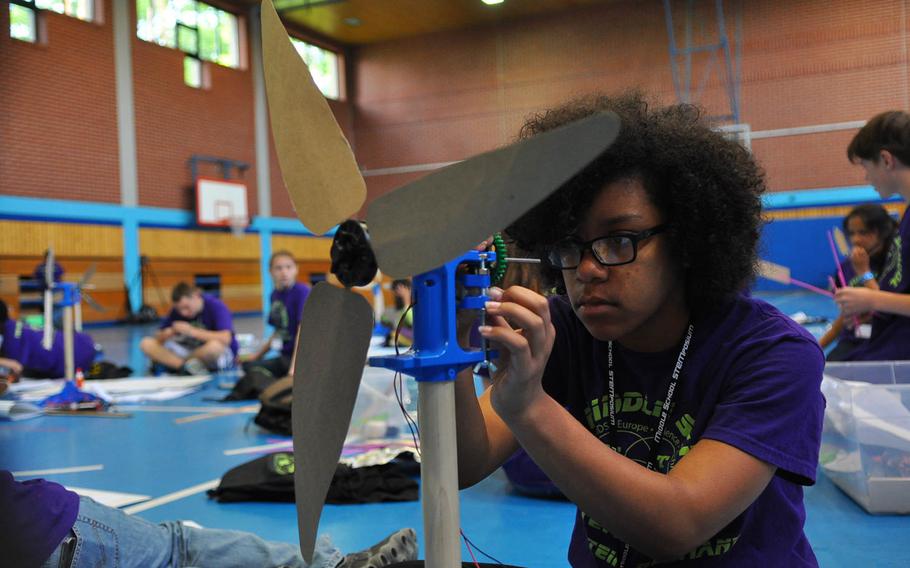 Kahliya Jones, an eighth-grader at Bitburg Middle/High School, adjusts a component on her wind turbine during the middle school STEMposium on Thursday, May 14, 2015, at Ramstein Air Base, Germany.