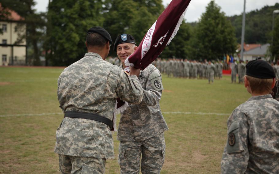 Col. James A. Laterza accepts the colors of Landstuhl Regional Medical Center from Europe Regional Medical Command's Brig. Gen. Norvell V. Coots during a change of command ceremony Friday, May 29, 2015. Laterza assumed command from Col. Judith Lee, who is moving to a position in the Army surgeon general's office.