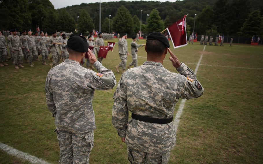Europe Regional Medical Command's Brig. Gen. Norvell V. Coots, right, and Col. James A. Laterza salute as soldiers pass in review following Landstuhl Regional Medical Center.'s change of command ceremony Friday, May 29, 2015. Laterza assumed command of the hospital from Col. Judith A. Lee, who is moving on to a position in the Army surgeon general's office.