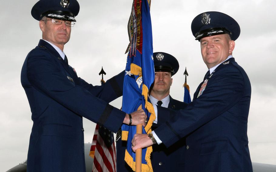 U.S. Air Force Lt. Gen. Darryl L. Roberson, left, 3rd Air Force and 17th Expeditionary Air Force commander, gives command of the 100th Air Refueling Wing to U.S. Air Force Col. Thomas D. Torkelson, right, during the 100th ARW change-of-command ceremony, Friday, May 29, 2015, at RAF Mildenhall, England. Torkelson replaced Col. Kenneth T. Bibb Jr.
