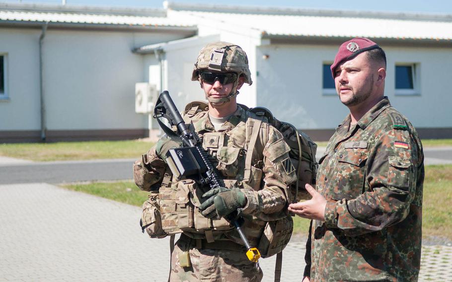 German 1st Sgt. Andreas Gross talks about military appearance to students attending the 7th U.S. Army Noncommissioned Officer Academy before a training event, June 5, 2015, in Grafenwoehr, Germany. Gross is the academy's first foreign military instructor.