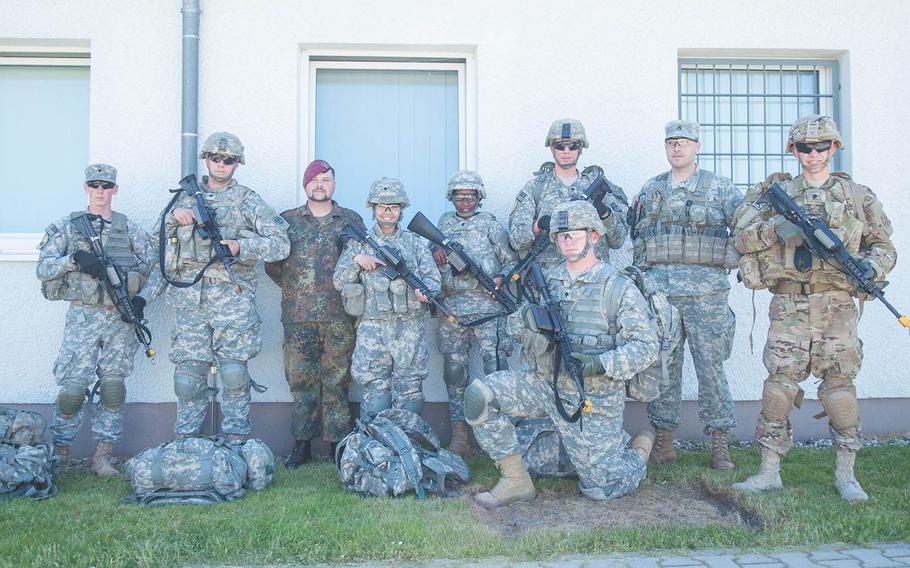 German 1st Sgt. Andreas Gross poses with soldiers who attended the first course he taught as an instructor at the 7th U.S. Army Noncommissioned Officer Academy in Grafenwoehr, Germany, June 5, 2015. 