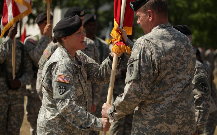 Col. Janell E. Eickhoff, the new commander of the 10th Army Air and Missile Defense Command, takes the unit's colors from U.S. Army Europe commander Lt. Gen. Ben Hodges during a change of command ceremony Friday, June 12, 2015, at Daenner Kaserne in Kaiserslautern, Germany.