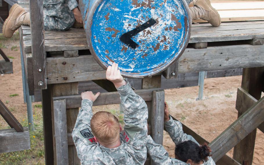 Junior ROTC cadets from Delta Company 2 tackle a teamwork-building exercise while at the leadership reaction course at U.S. Army Garrison Grafenwoehr, Germany, on June 18, 2015.