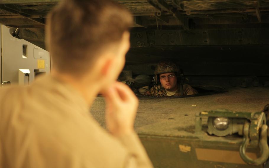 Spc. Seth Lantz, an Abrams tank driver with Company C, 3rd Combined Arms Battalion, 69th Armor Regiment, waits for instructions from an Air Force crew chief while loading his M1A2 tank onto an Air Force C-17 Saturday, June 20, 2015, at Rammstein Air Base in Germany. The tank is one of two headed to Bulgaria for a live-fire exercise next week.