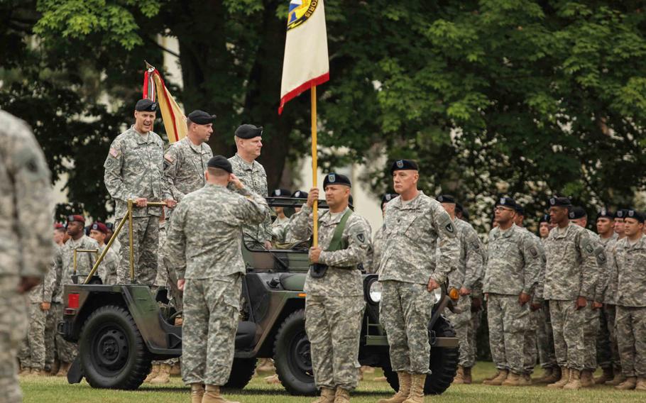 Maj. Gen. John R. O'Connor, outgoing commander of the 21st Theater Sustainment Command, Lt. Gen. Ben Hodges , commander of U.S. Army Europe, and Maj. Gen. Duane A. Gamble, the new commander of the 21st, ride in a jeep while trooping the line at the TSC's change of command ceremony Wednesday, June 24, 2015, in Kaiserslautern, Germany.