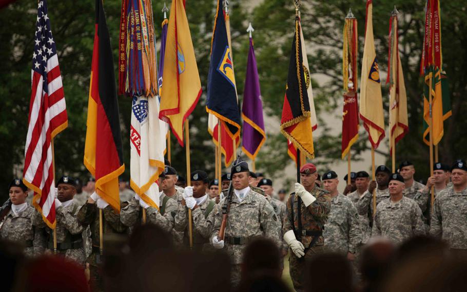 National and Army flags and colors of various units of the 21st Theater Sustainment Command are brought together during the unit's change of command ceremony Wednesday, June 24, 2015, in Kaiserslautern, Germany.
