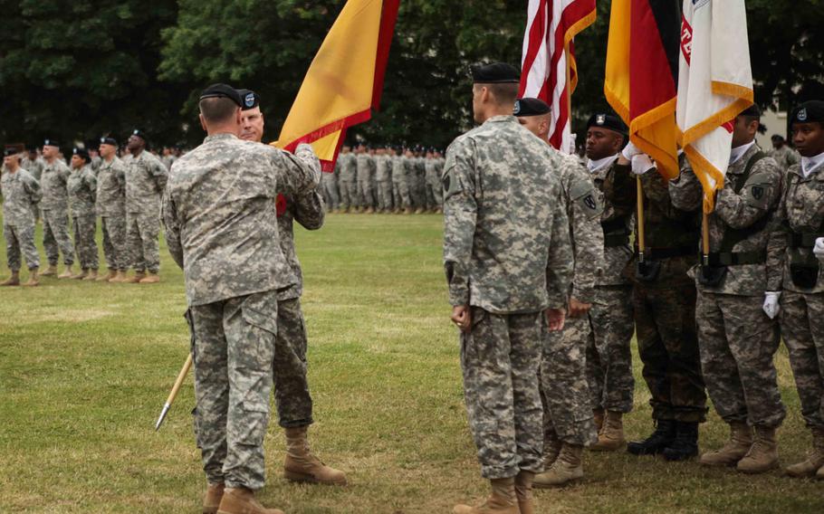 U.S. Army Europe commander Lt. Gen. Ben Hodges hands the colors of the 21st Theater Sustainment Command to its new commander, Maj. Gen. Duane A. Gamble, during the 21st Theater Sustainment Command's change of command ceremony Wednesday, June 24, 2015, in Kaiserslautern, Germany.