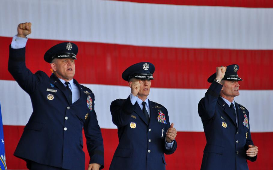 Gen. Frank Gorenc, Lt. Gen. Timothy M. Ray and Lt. Gen. Darryl L. Roberson pump their fists while singing the Air Force song at the end of a change of command for 3rd Air Force on Thursday, July 2, 2015, at Ramstein Air Base in Germany. Gorenc, left, commander of U.S. Air Forces in Europe and Africa, presided over the ceremony, in which Ray, center, assumed command of 3rd Air Force from the outgoing Roberson.
