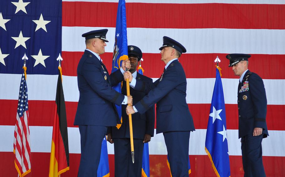 Gen. Frank Gorenc, commander of U.S. Air Forces in Europe and Africa, hands the unit colors of 3rd Air Force to its new commander,  Lt. Gen. Timothy M. Ray, during a change of command ceremony Thursday, July 2, 2015, at Ramstein Air Base in Germany.