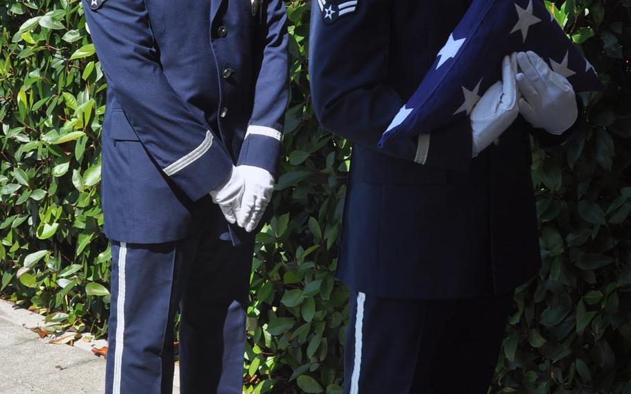 Airman 1st Class Roger Lanoie holds the flag while fellow 31st Fighter Wing Honor Guard member Senior Airman Joshua Sharer stands by during a flag-folding demonstration to visitors at Aviano Air Base, Italy, Friday, July 10, 2015.