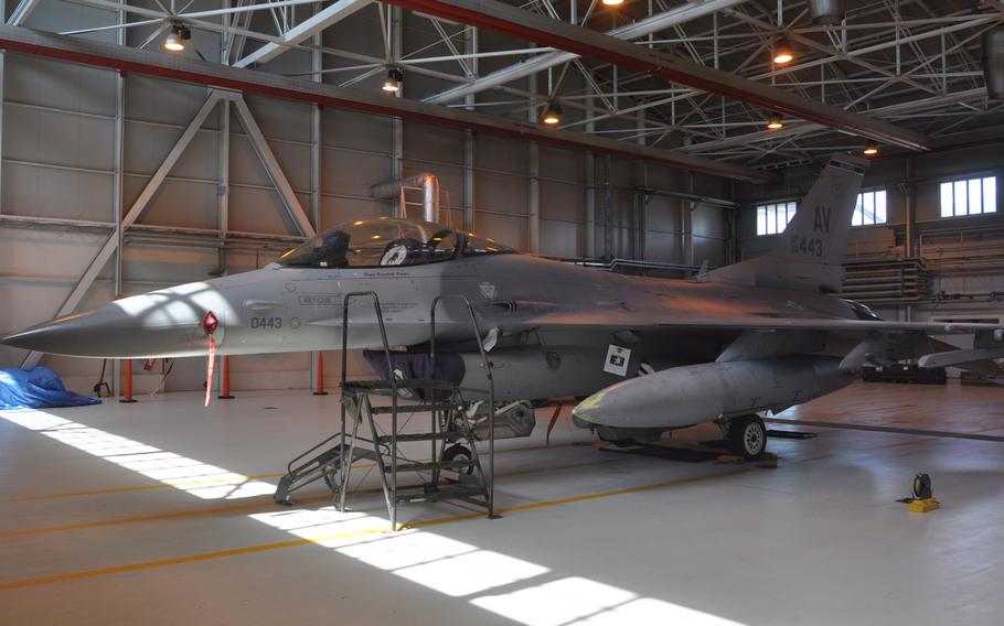 An F-16 Fighting Falcon provided by the 31st Fighter Wing's 510th Fighter Squadron sits on display Friday, July 10, 2015, as a group of visitors prepare to enter the hanger at Aviano Air Base, Italy.