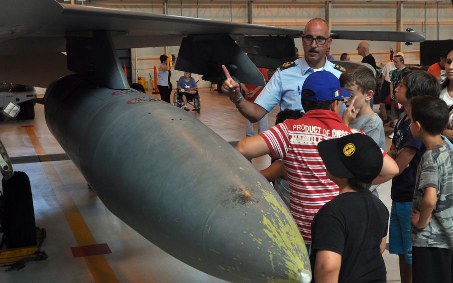 ITAF Technical Sergeant Zecca Stefano talks about different aspects of the F-16 Fighting Falcon on display Friday, July 10, 2015, at Aviano Air Base, Italy.