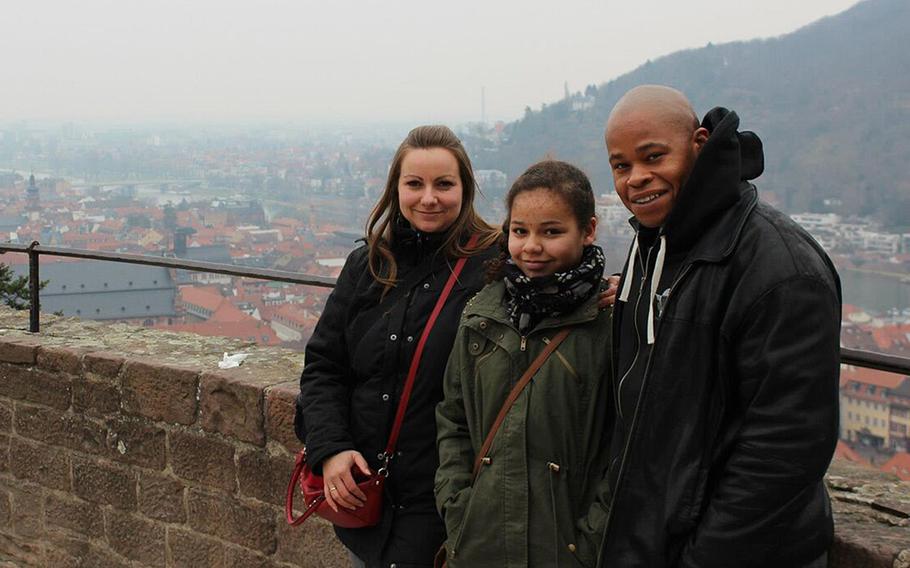 Amber Walker, then 10, stands between her parents, Claudia and Edmond, a U.S. Army staff sergeant, at Heidelberg Castle in Heidelberg, Germany, in 2013. Amber was killed on a ride at Holiday Park in Hassloch, Germany, in August 2014. German prosecutors announced this week that three park employees have been charged with negligent homicide in connection with Amber's death. Claudia Walker wants the park placed off-limits to U.S. military personnel in Europe.