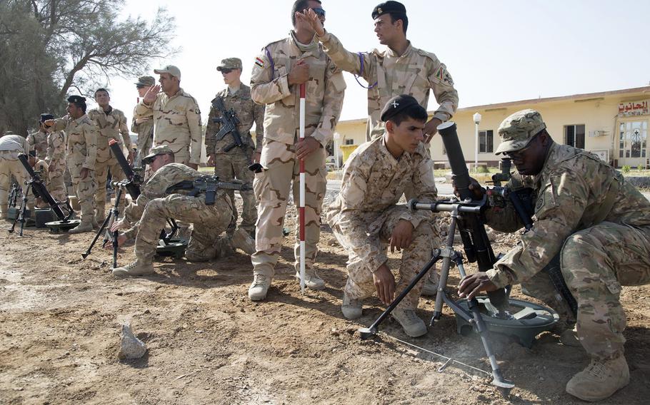 U.S. Soldiers assigned to Alpha Troop, 5th Squadron, 73rd Cavalry Regiment, 3rd Brigade Combat Team, 82nd Airborne Division, assist Iraqi soldiers assigned to the 73rd Brigade, 16th Division, with M224 60 mm mortar systems at Camp Taji, Iraq, June 25, 2015. On Friday, NATO announced it would join efforts to train Iraqi security forces, but the NATO mission will take place in Turkey and Jordan rather than inside Iraq.