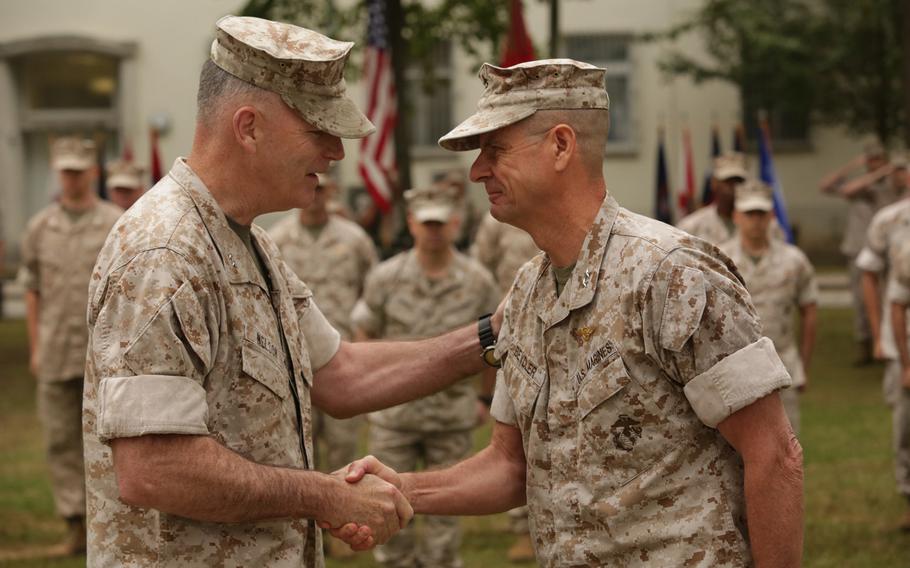 The incoming commander of Marine forces in Europe and Africa, Maj. Gen. Niel Nelson, left, and Maj. Gen. William Beydler shake hands at the change-of-command ceremony in Stuttgart, Germany, Wednesday, Aug. 19, 2015.