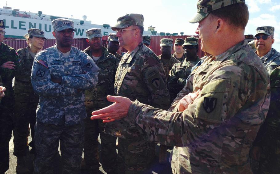 U.S. Army Europe leader Lt. Gen. Ben Hodges, center, talks strategy with Lt. Gen. Larry Wyche, deputy commander of U.S. Army Material Command, and Maj. Gen. Duane Gamble, head of the 21st Theater Sustainment Command, during a visit to the port at Bremerhaven, Germany. As part of USAREUR?s Terrain Walk, Army leaders traveled to various ports and logistical hubs to investigate ways to improve the flow of combat equipment into Europe.