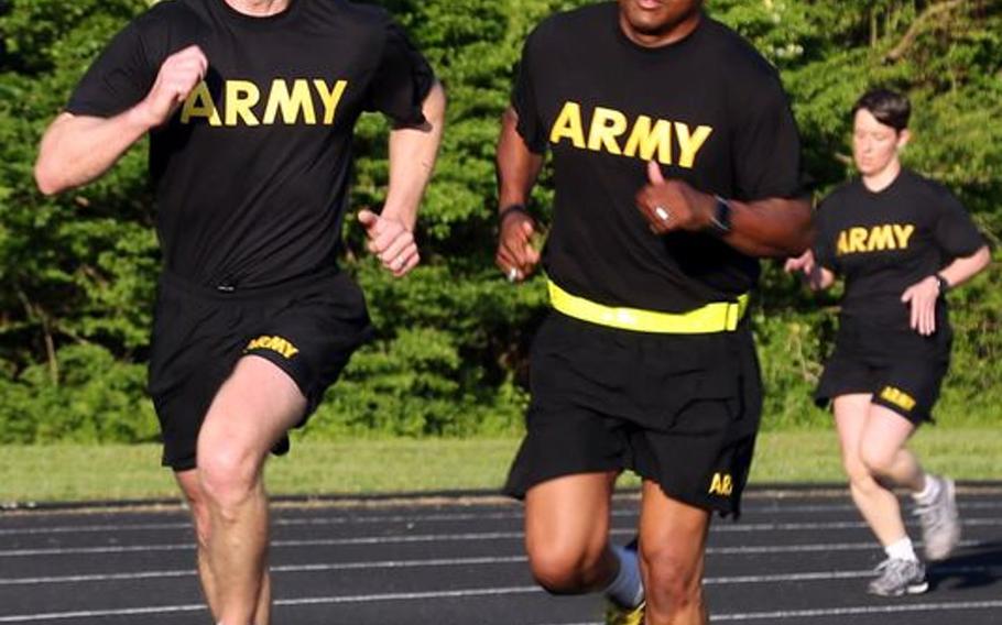 Sgt. Maj. of the Army Dan Dailey, left, conducts physical training with soldiers at Redstone Arsenal, Ala. in May 2015. Dailey, who took the position in January, has said he supports soldiers being able to wear black socks with their physical fitness uniforms. Current Army regulations state soldiers must wear plain white socks of at least ankle length.